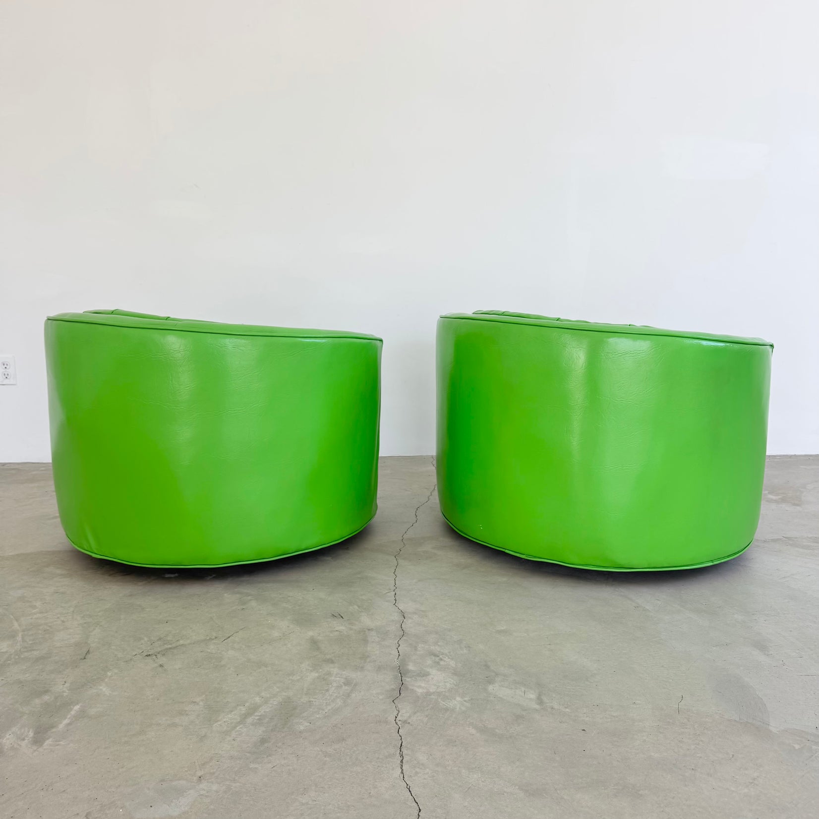 Pair of Green Vinyl Swivel Chairs