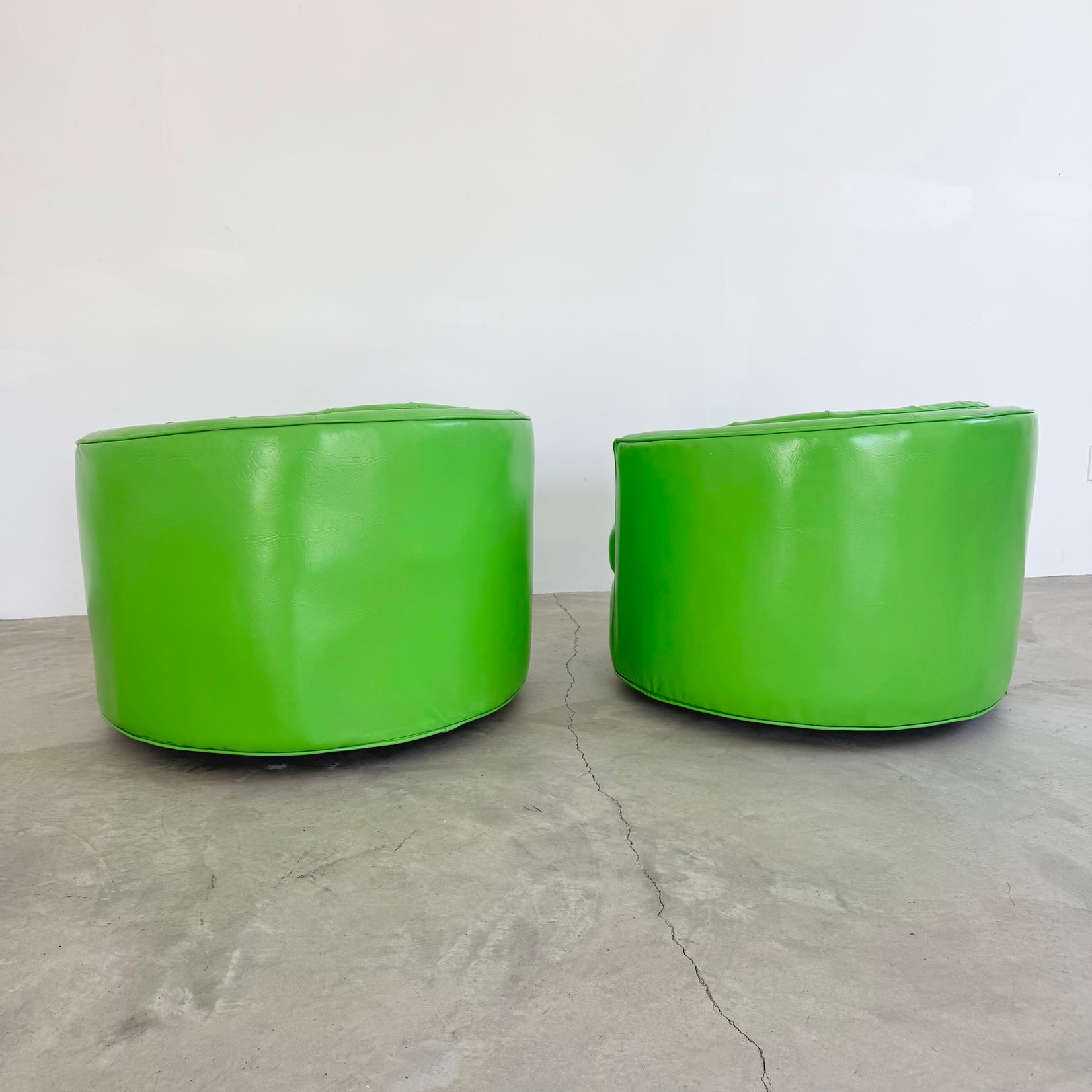 Pair of Green Vinyl Swivel Chairs