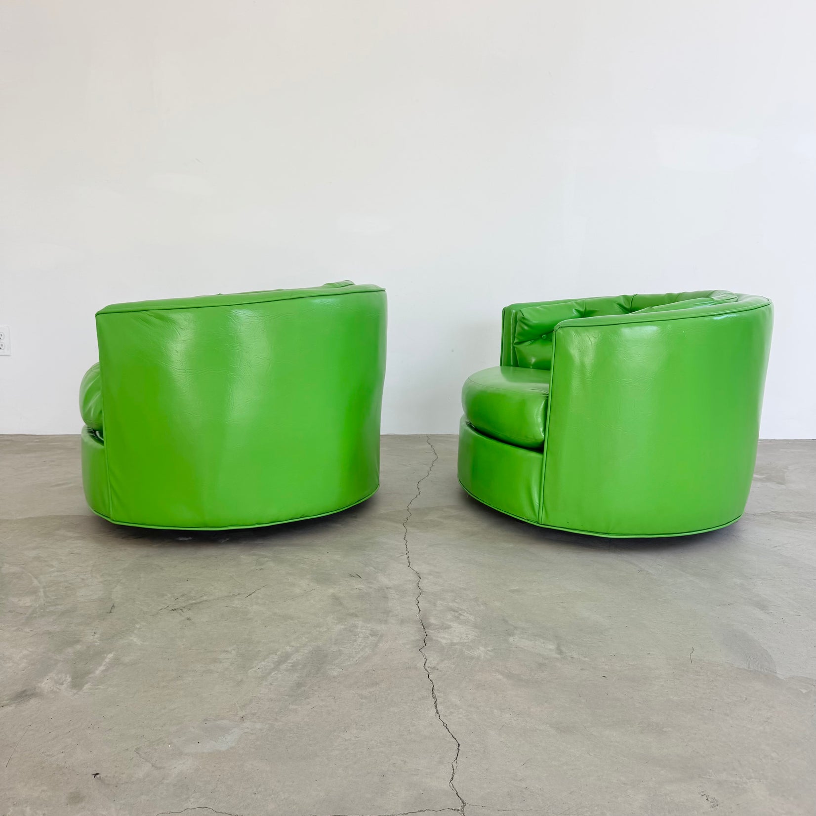 Pair of Green Vinyl Swivel Chairs