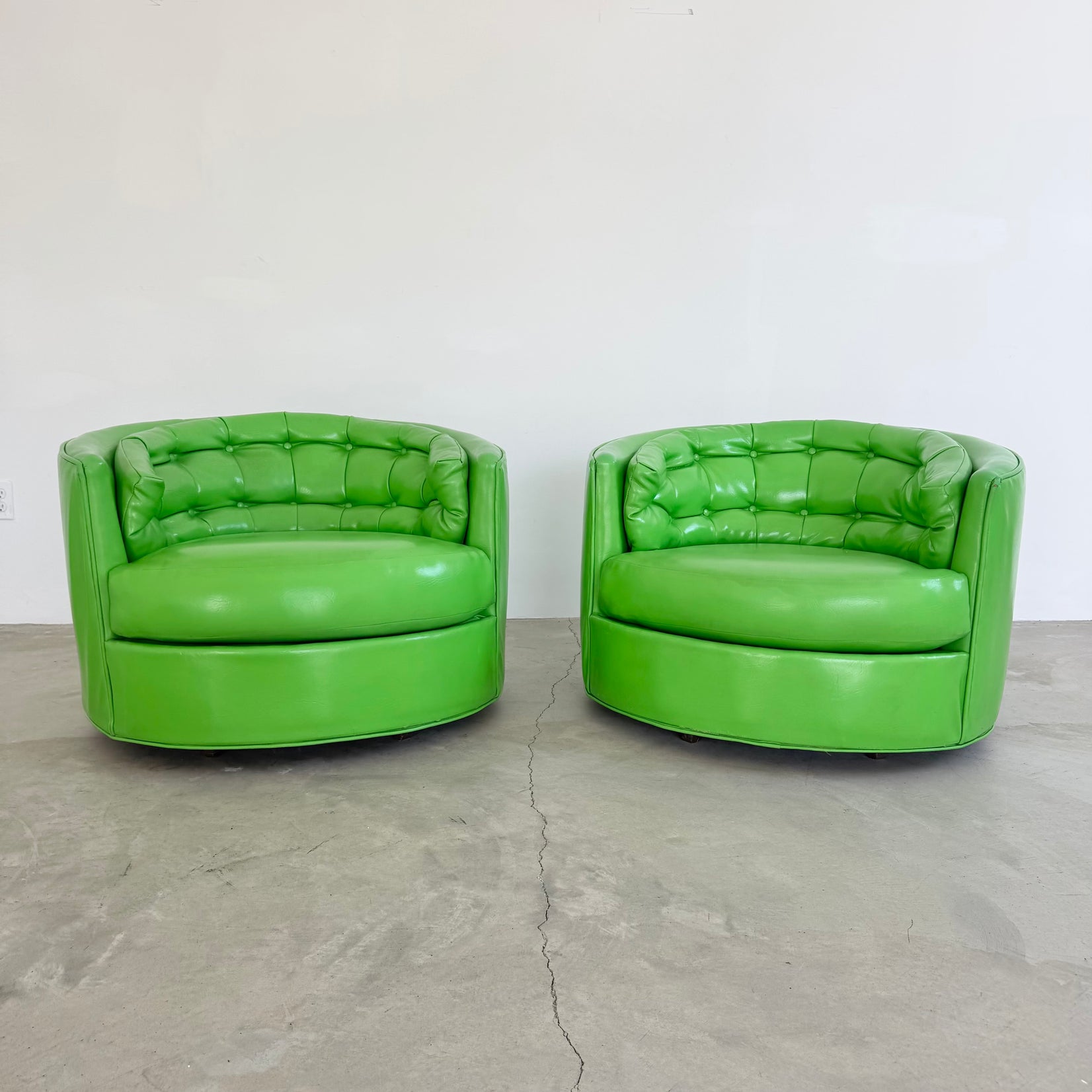 Pair of Green Vinyl Swivel Chairs
