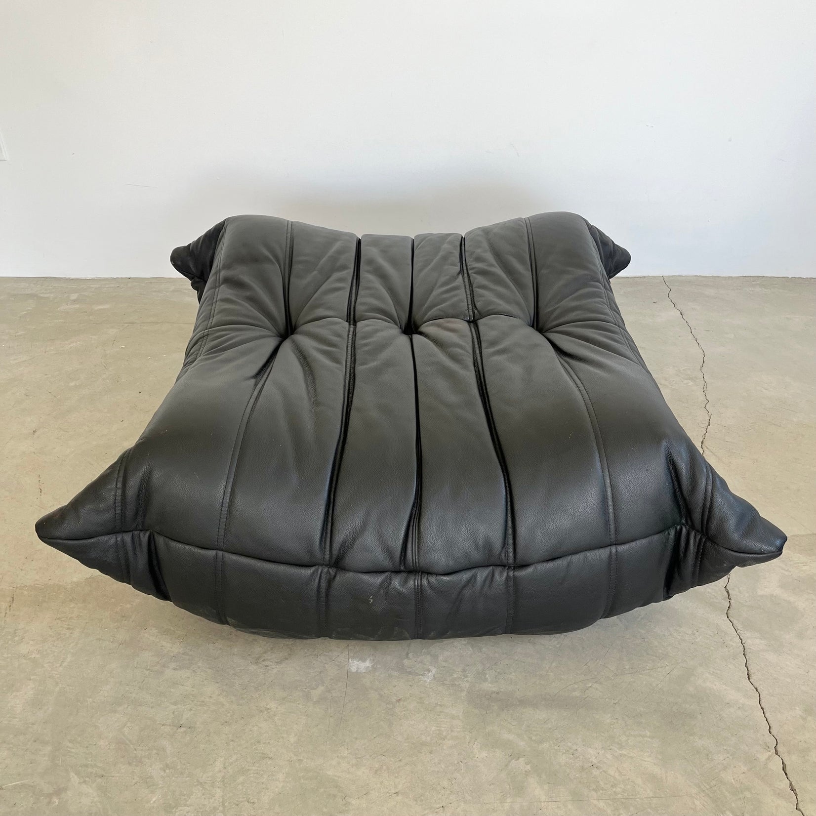 Black leather Togo Ottoman