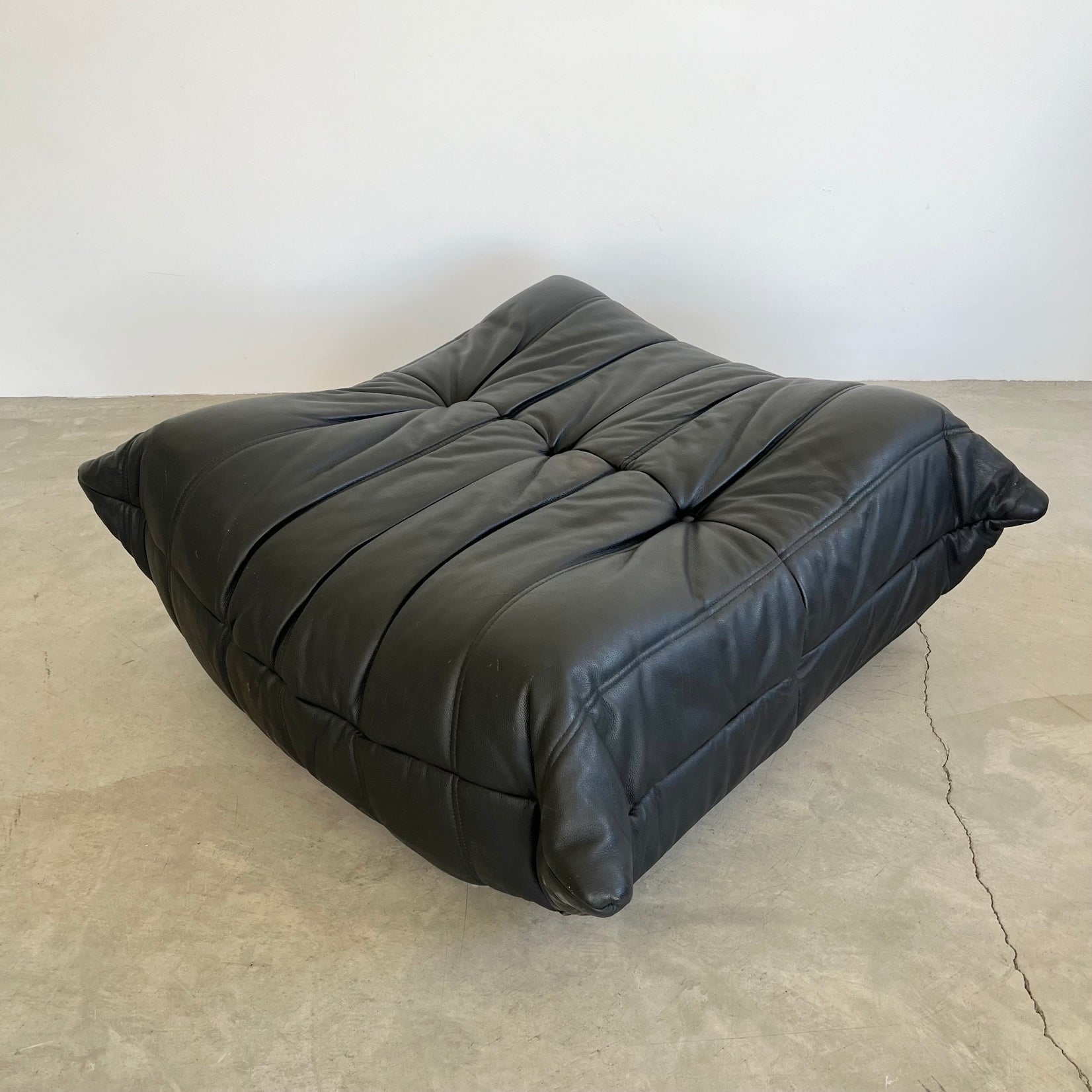 Black leather Togo Ottoman