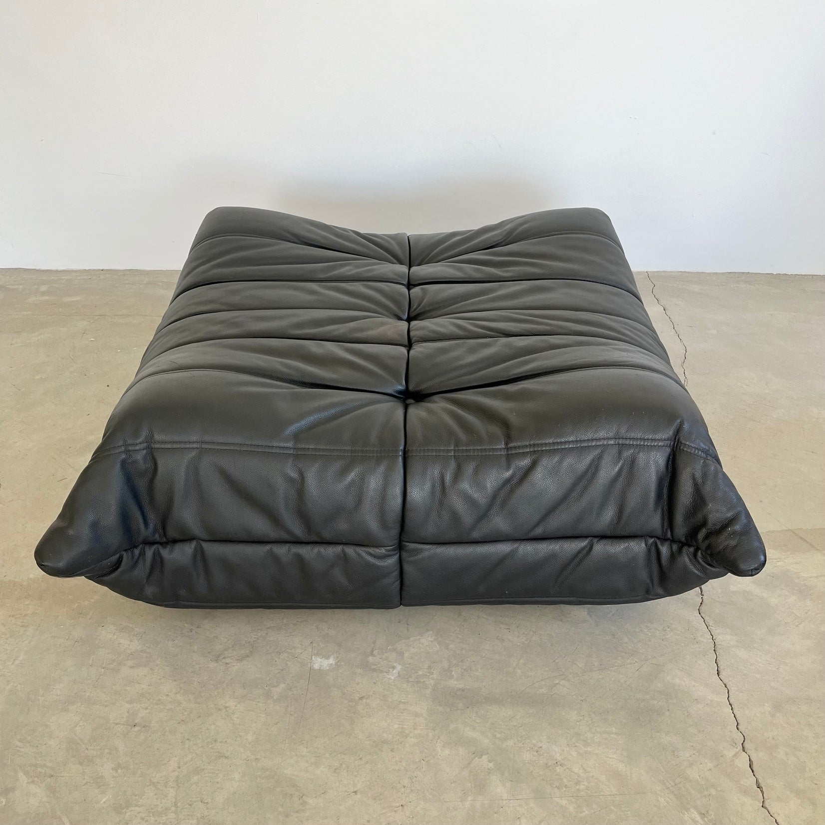 Black leather Togo Ottoman