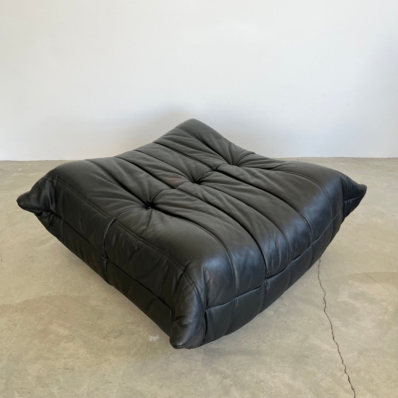 Black leather Togo Ottoman