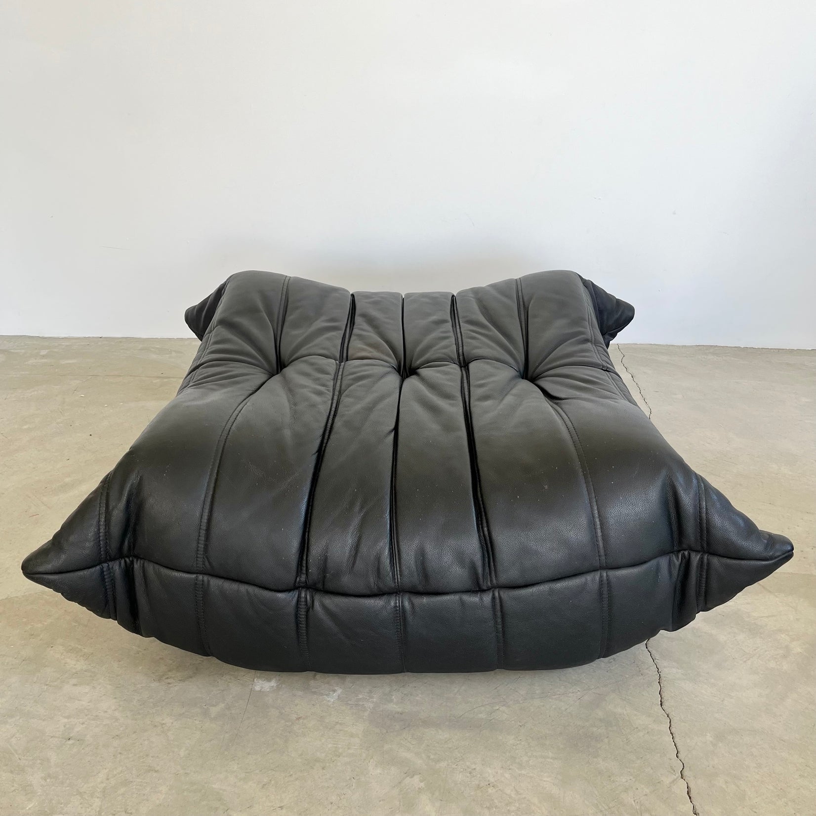 Black leather Togo Ottoman