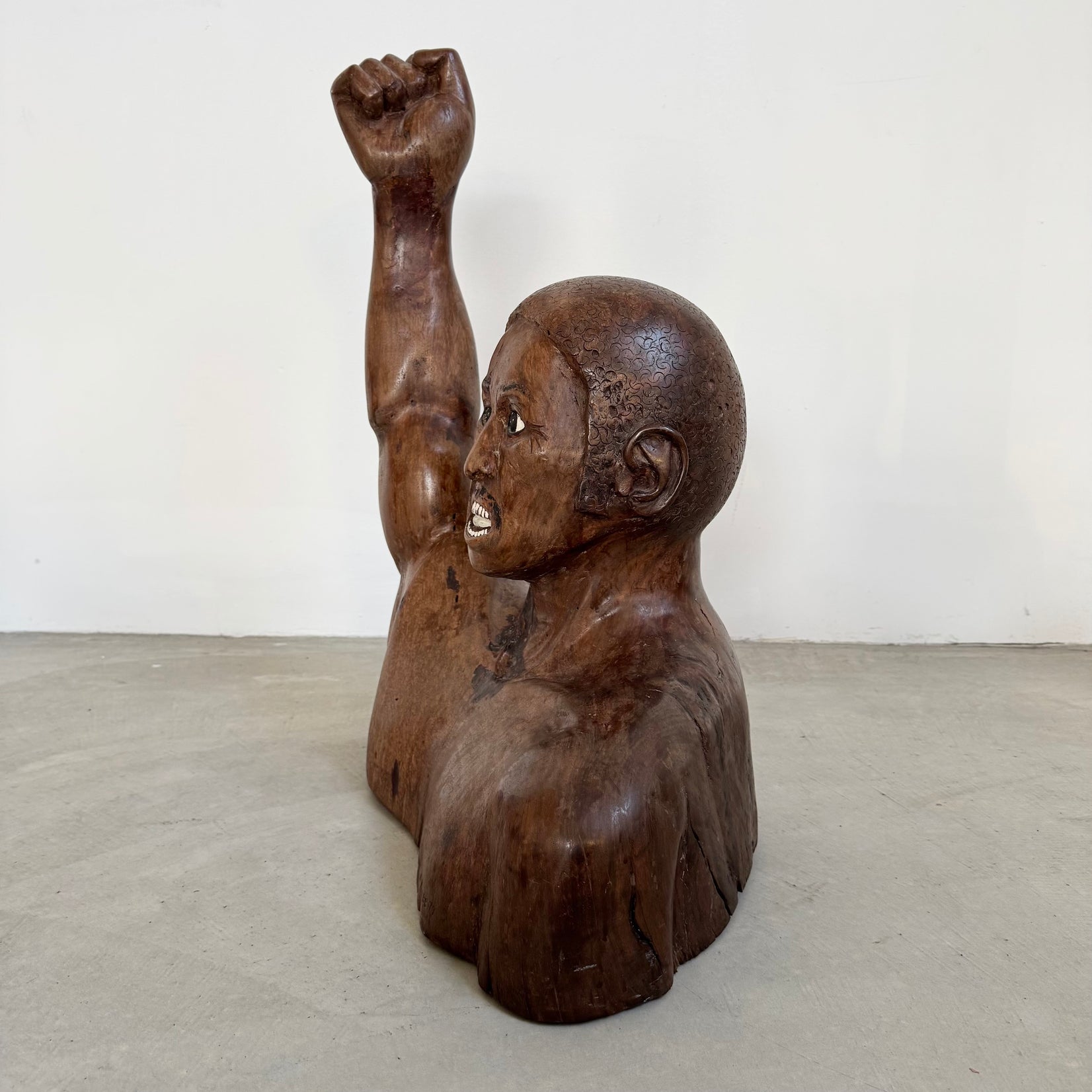 Raised Fist Wood Carving