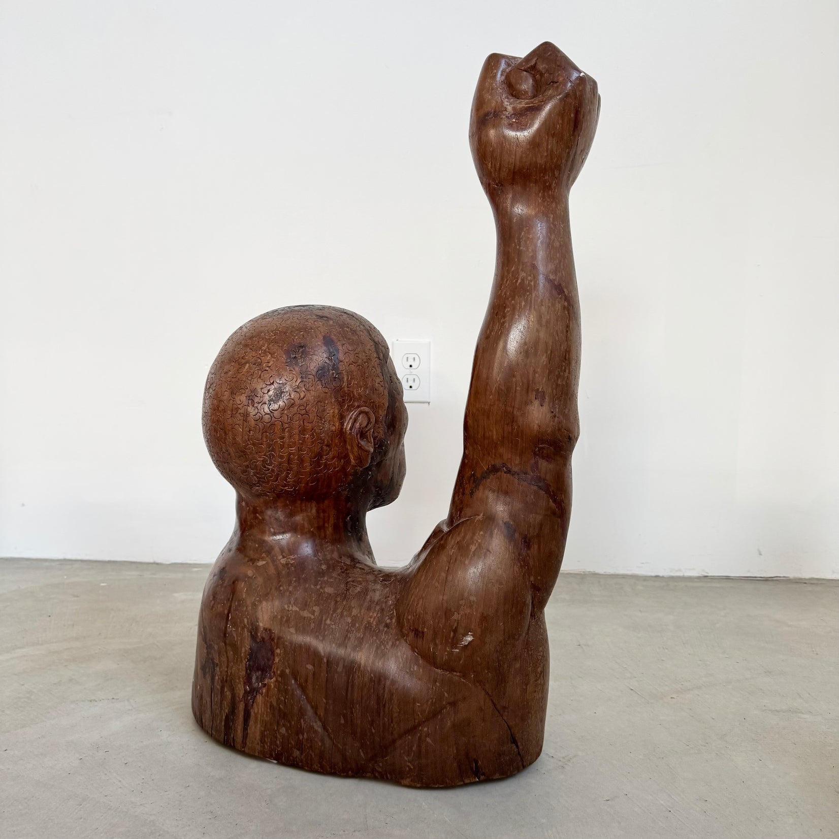 Raised Fist Wood Carving