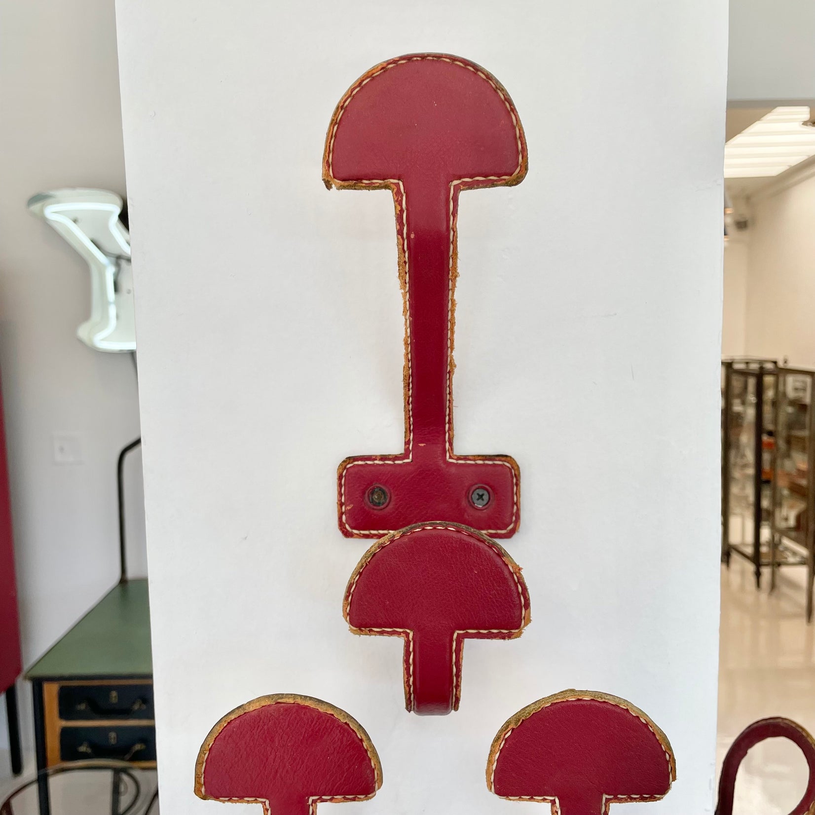Set of three Jacques Adnet Red Leather Coat Hooks, 1950s France