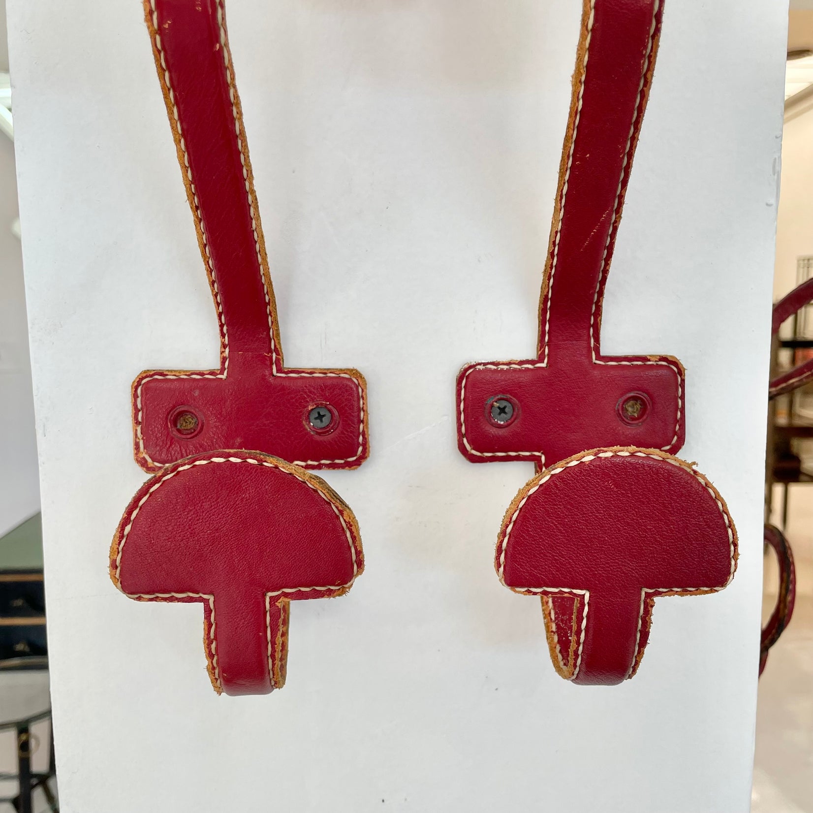 Set of three Jacques Adnet Red Leather Coat Hooks, 1950s France